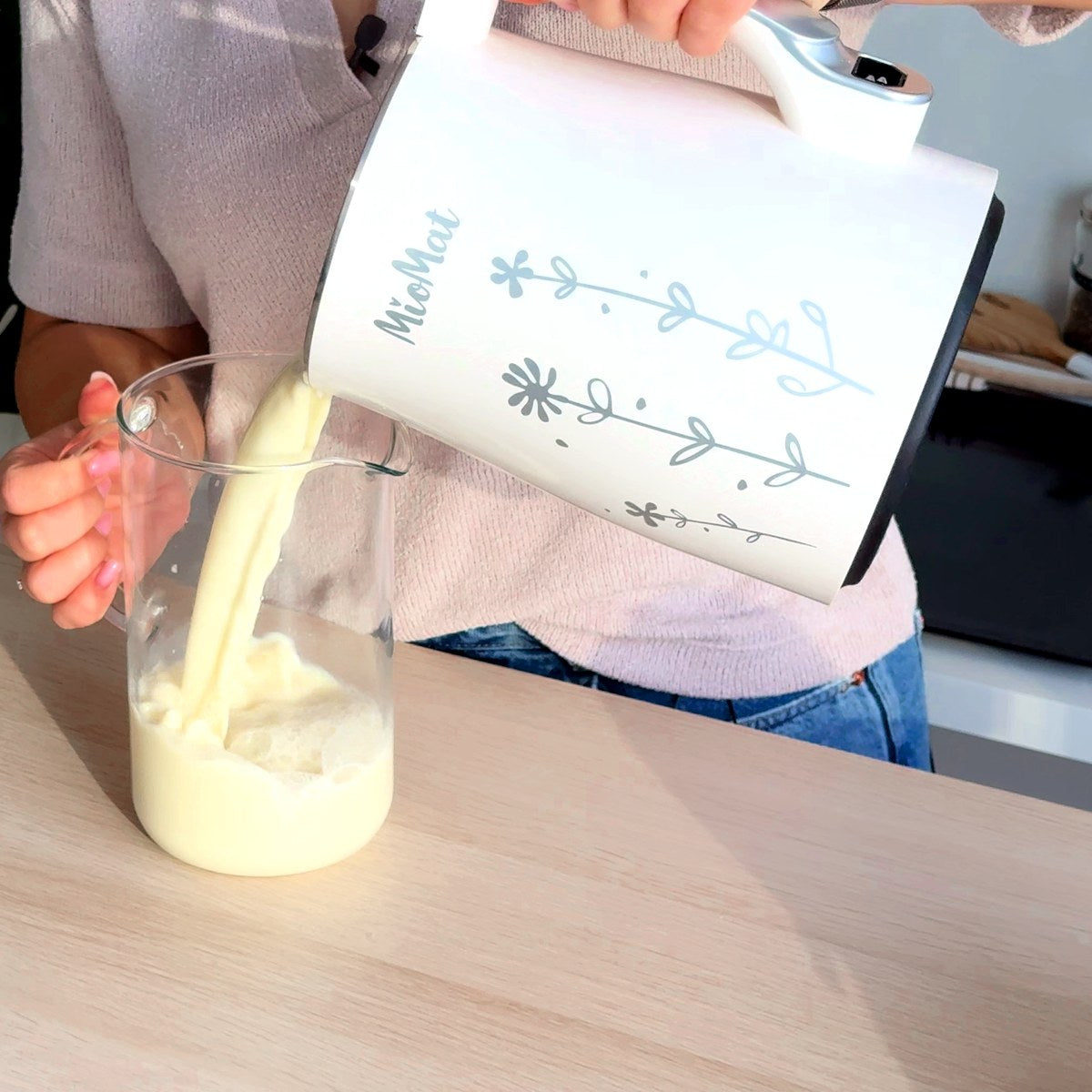 Fresh soy milk poured from the MioMat into a glass jar