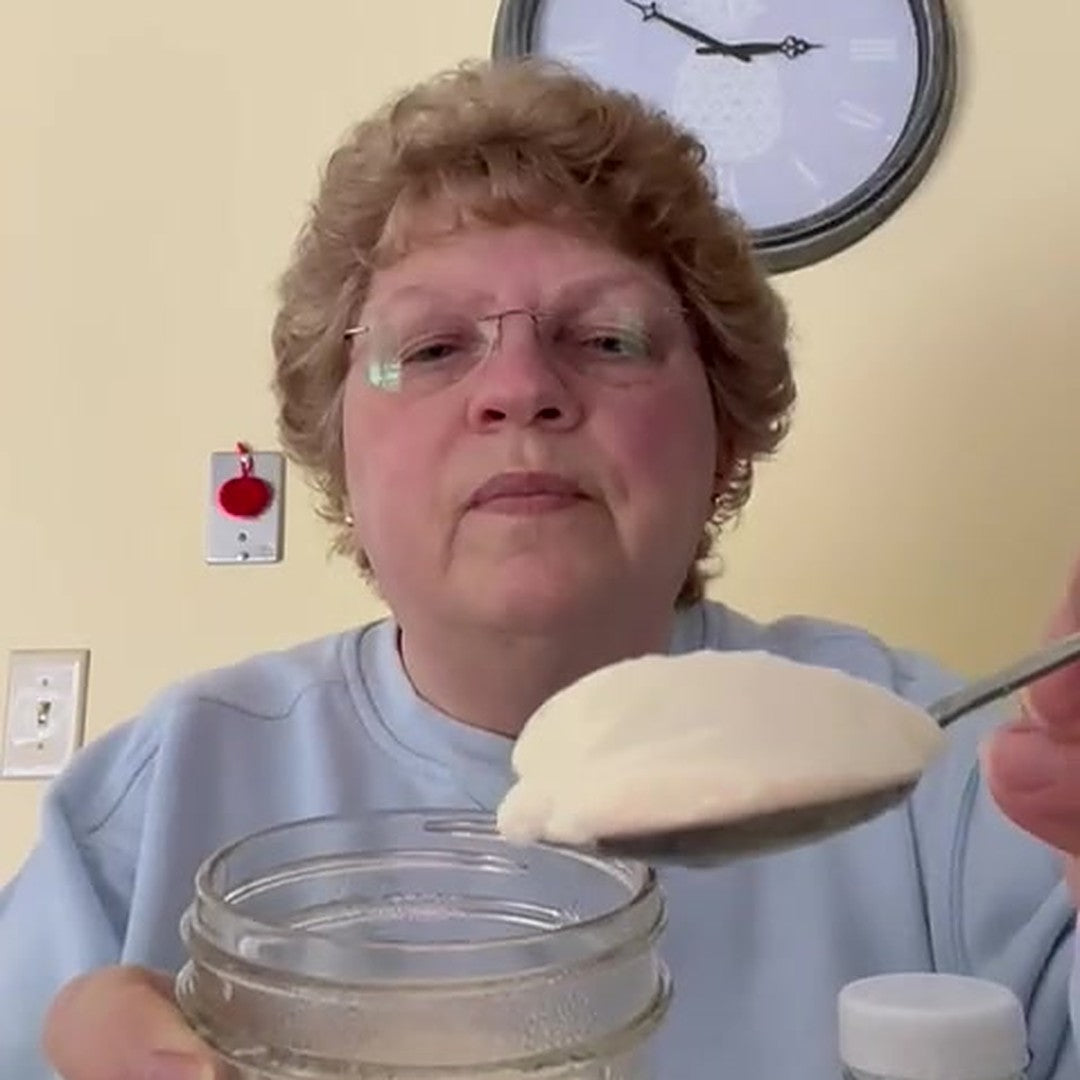 Course tester Lynne lifting a spoon of her homemade soy yogurt
