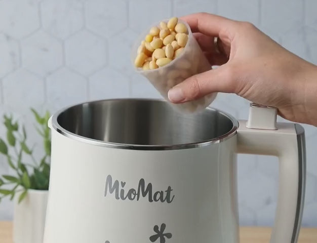 Soybeans poured into the MioMat, milk poured into iced coffee, thick yogurt, and fresh plant-based cheese pressed with a finger